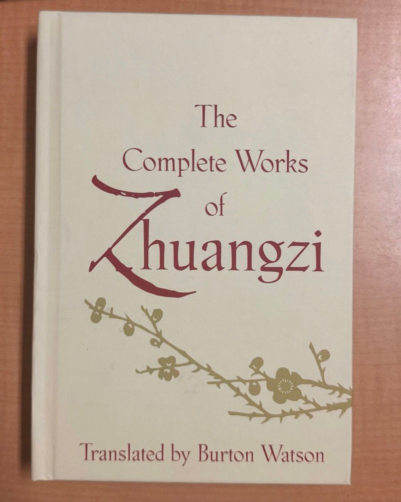 A cream hardcover of The Complete Works of Zhuangzi, translated by Burton Watson, with a plum-blossom branch on the cover